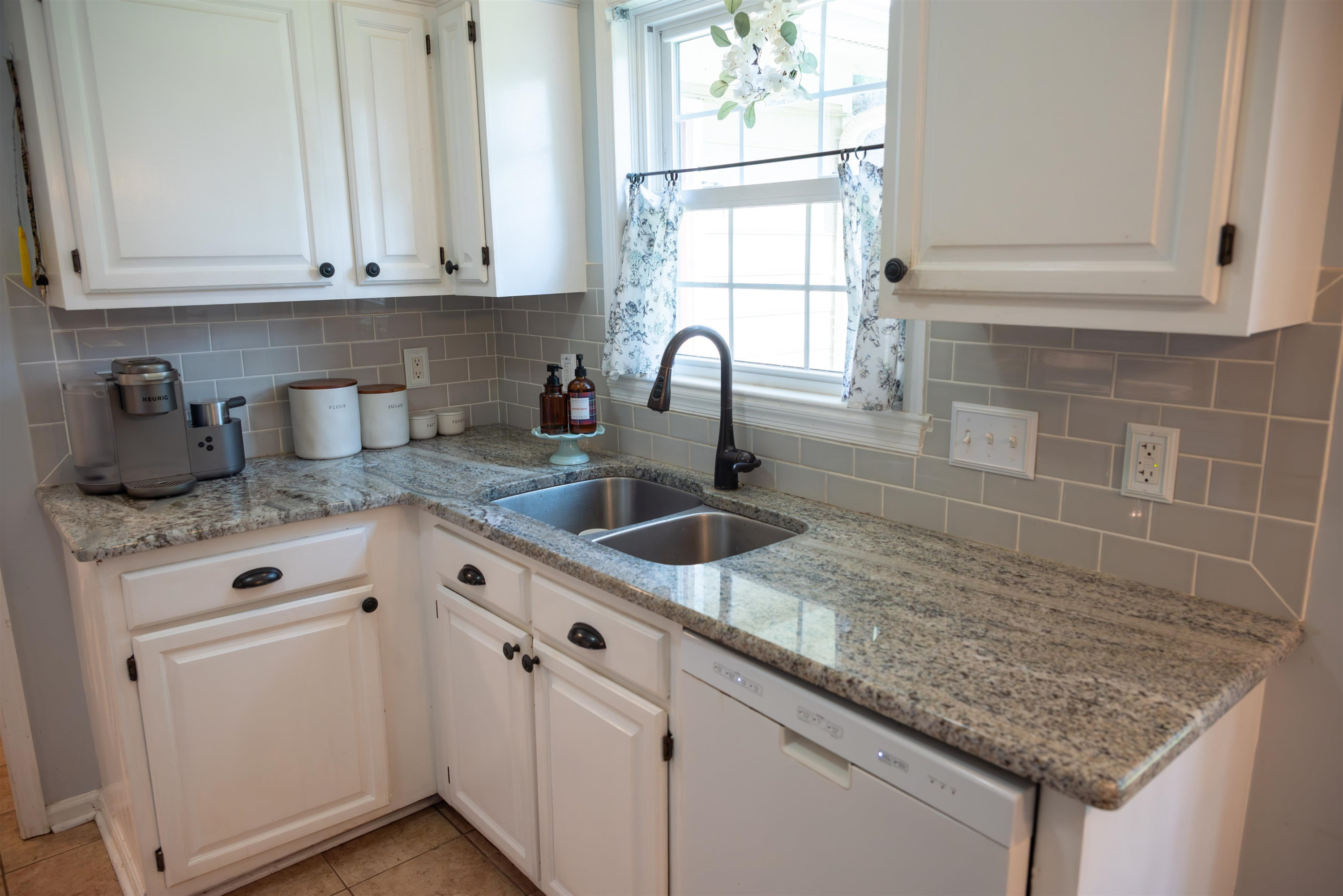 1301 Buckhorn Road Garner, NC 27529 - Photo 10 of 24 a kitchen with granite countertop white cabinets and a sink