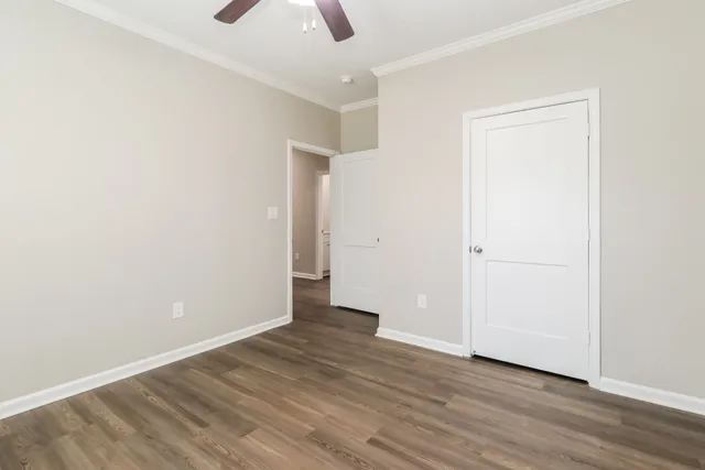 an empty room with wooden floor and closet