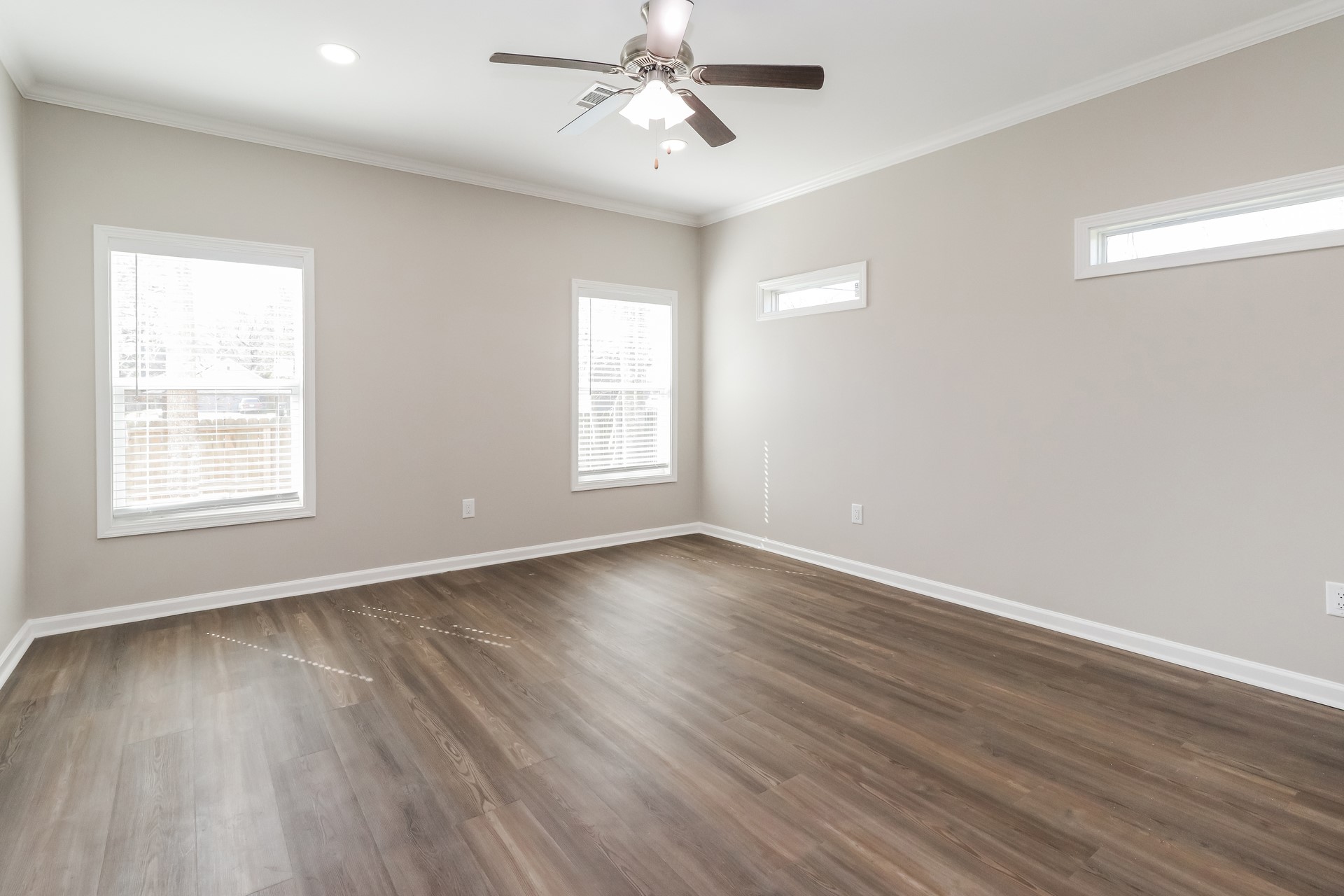 8516 Kellett Street Houston, TX 77028 - Photo 8 of 16 a view of an empty room with wooden floor and a window