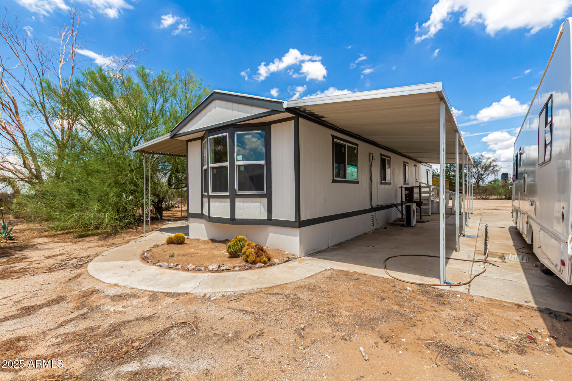 3663 North Thistle Drive Florence, AZ 85132 - Photo 11 of 29 a backyard of a house with table and chairs
