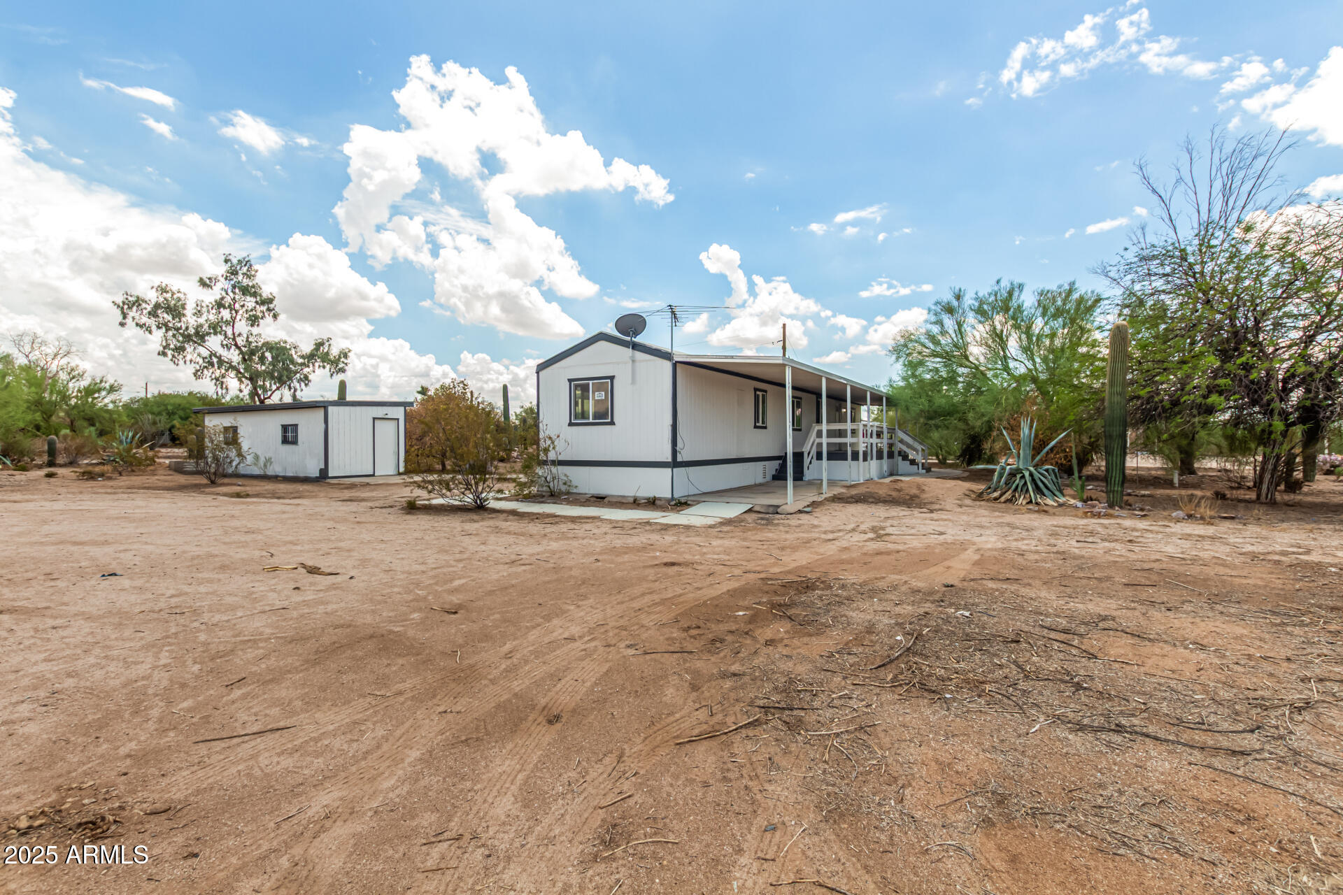 3663 North Thistle Drive Florence, AZ 85132 - Photo 14 of 29 a view of a house with a snow in the yard