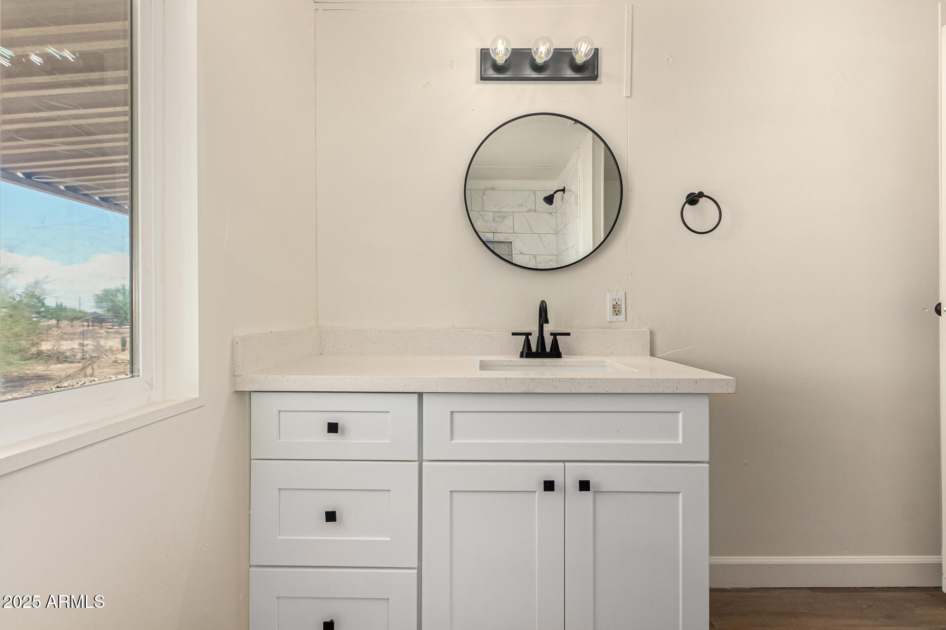 3663 North Thistle Drive Florence, AZ 85132 - Photo 27 of 29 a bathroom with a sink and a mirror