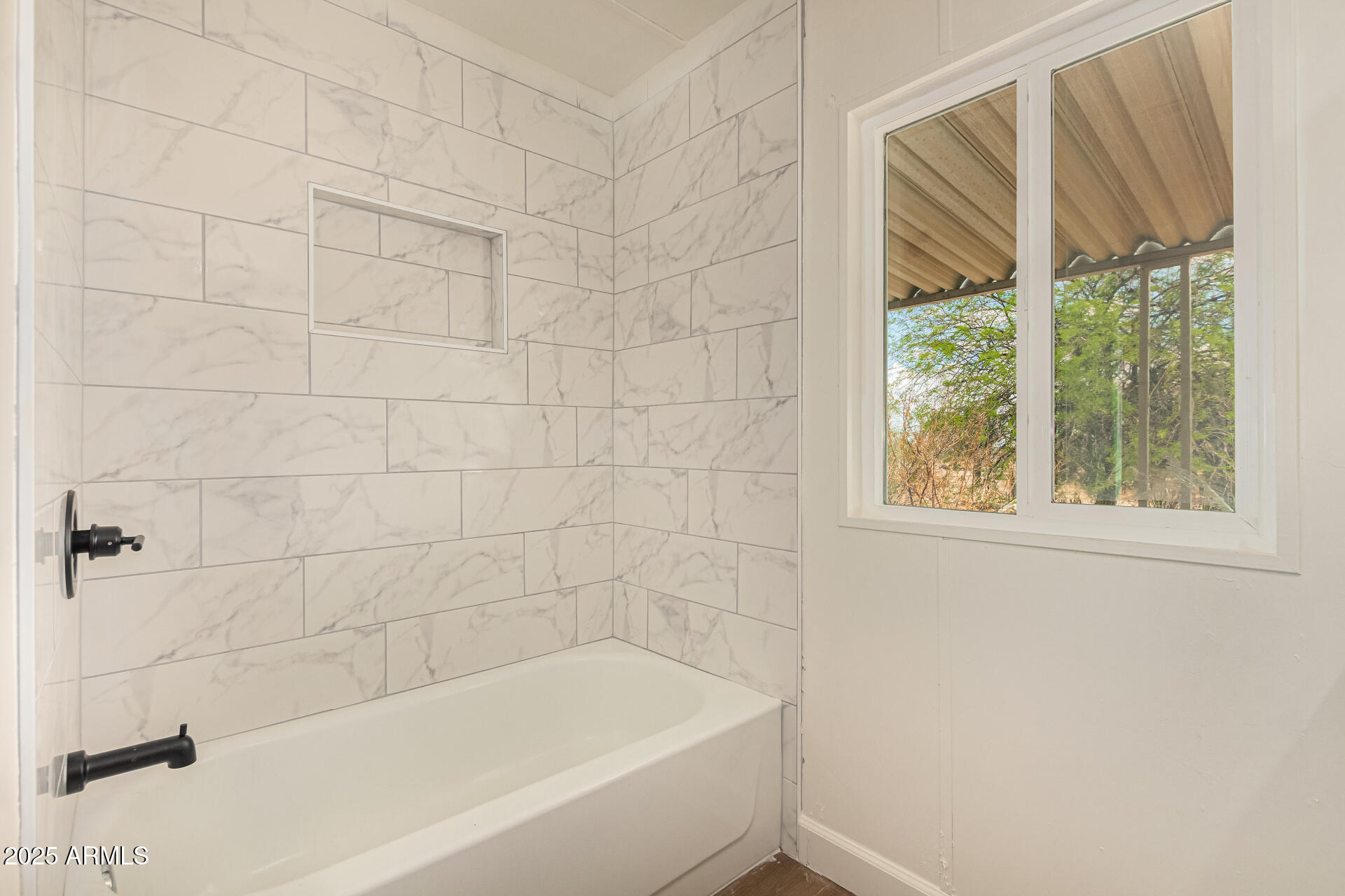 3663 North Thistle Drive Florence, AZ 85132 - Photo 3 of 29 a bathroom with a bathtub and window
