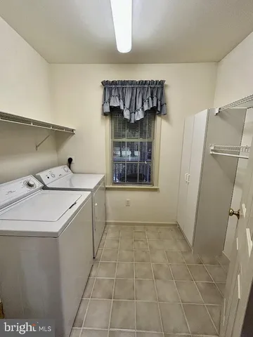 a large kitchen with a large counter top space a sink stainless steel appliances and cabinets