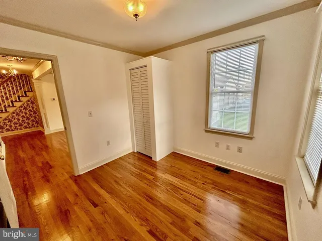 a kitchen with stainless steel appliances granite countertop a stove a sink and white cabinets