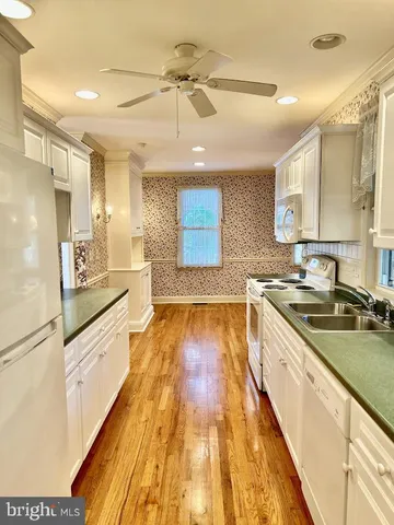a kitchen with stainless steel appliances granite countertop a sink and cabinets