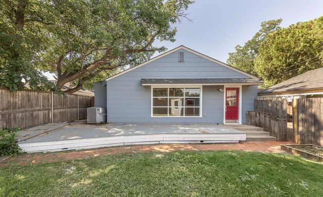 a front view of a house with a garden and yard