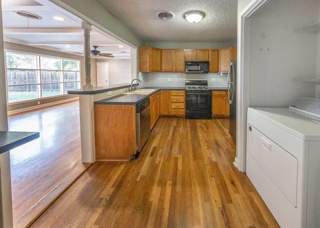 a kitchen with wooden floors and a sink