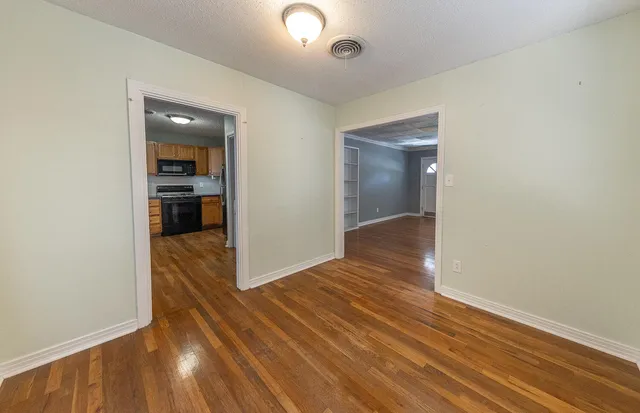 wooden floor in an empty room with a gallery
