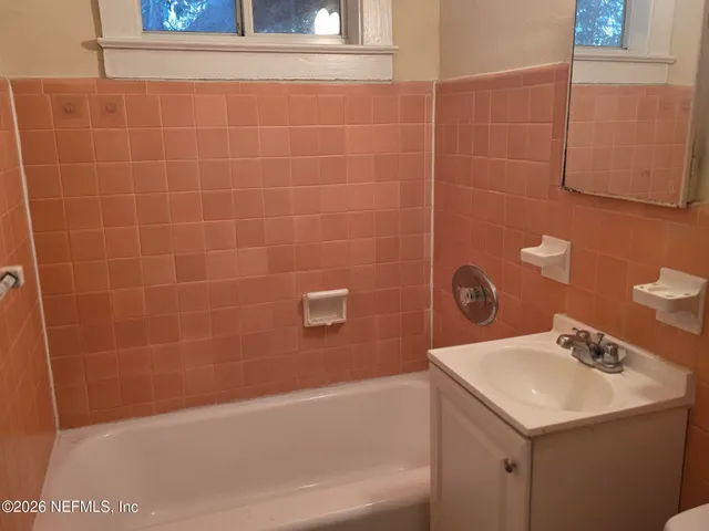 a bathroom with a sink and mirror