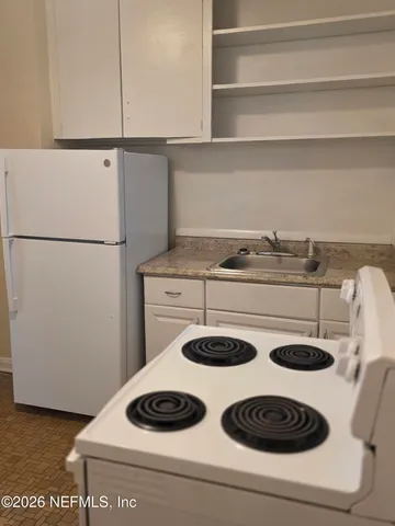 a kitchen with a stove and a refrigerator