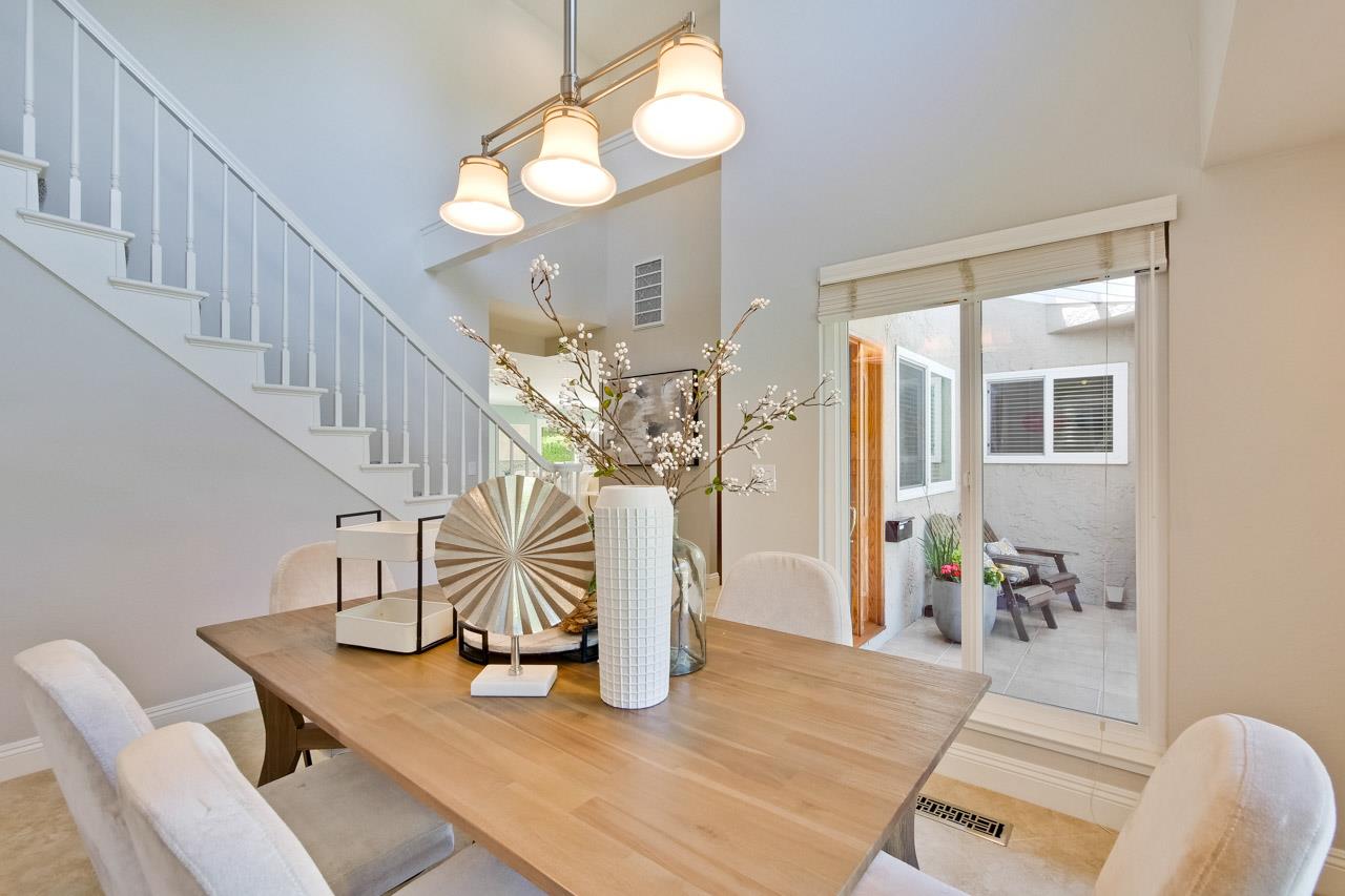 22266 Hartman Drive Cupertino, CA 95014 - Photo 12 of 73 a view of a dining room with furniture and a chandelier