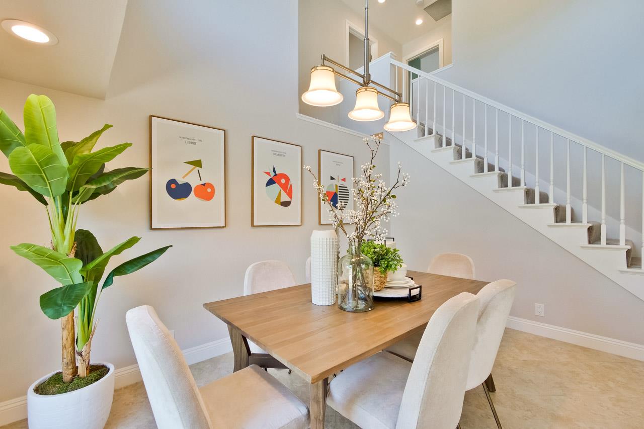 22266 Hartman Drive Cupertino, CA 95014 - Photo 13 of 73 a view of a dining room with furniture and a potted plant