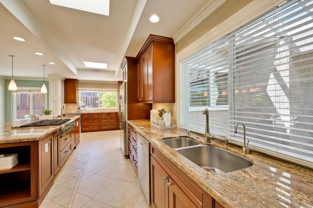 22266 Hartman Drive Cupertino, CA 95014 - Photo 15 of 73 a kitchen with stainless steel appliances granite countertop a sink and a stove