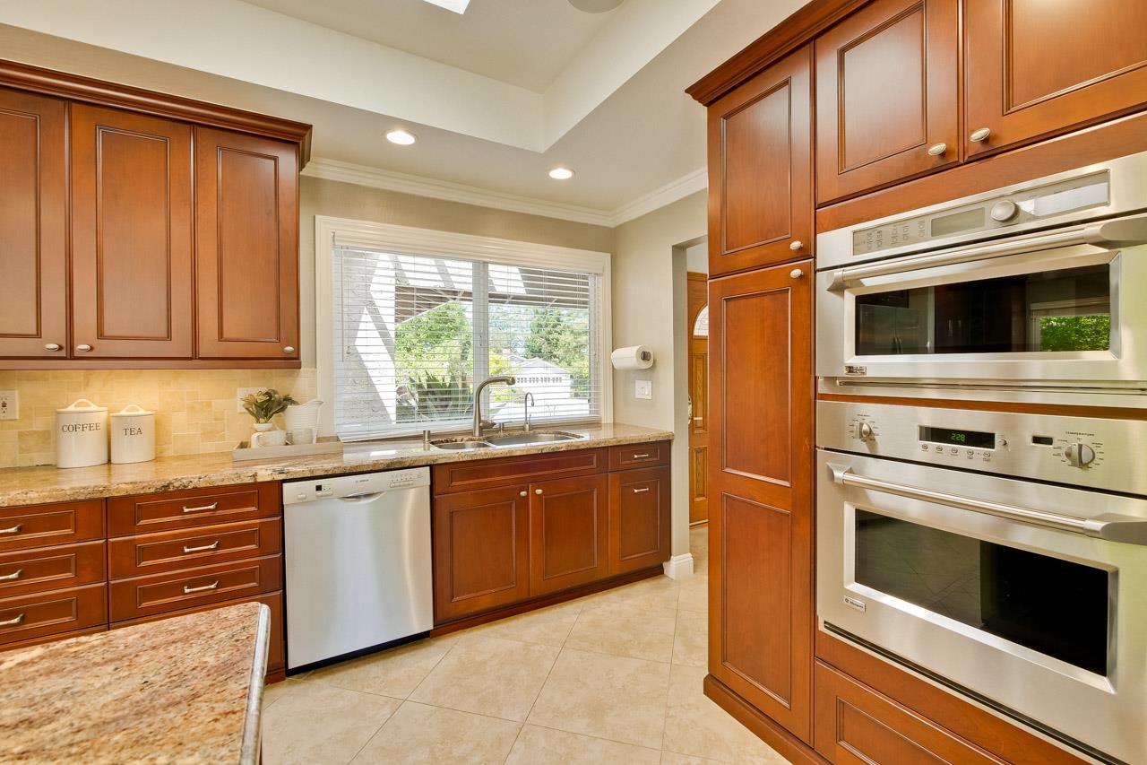 22266 Hartman Drive Cupertino, CA 95014 - Photo 18 of 73 a kitchen with stainless steel appliances granite countertop a stove microwave and cabinets