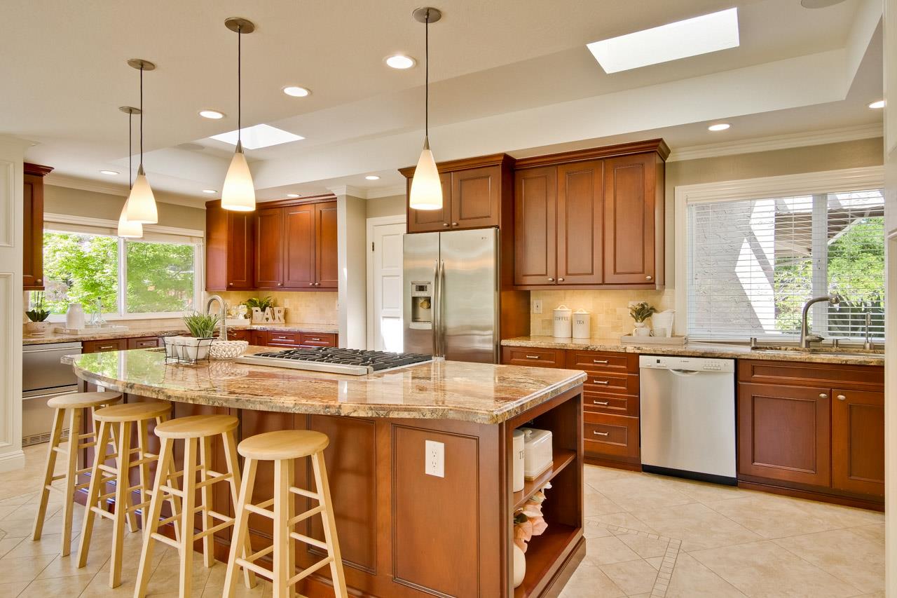 22266 Hartman Drive Cupertino, CA 95014 - Photo 19 of 73 a kitchen with stainless steel appliances granite countertop a stove a sink dishwasher and a refrigerator with wooden floor