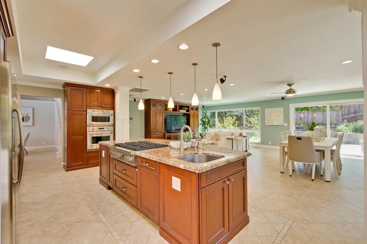 22266 Hartman Drive Cupertino, CA 95014 - Photo 21 of 73 a kitchen with stainless steel appliances granite countertop a sink and a refrigerator