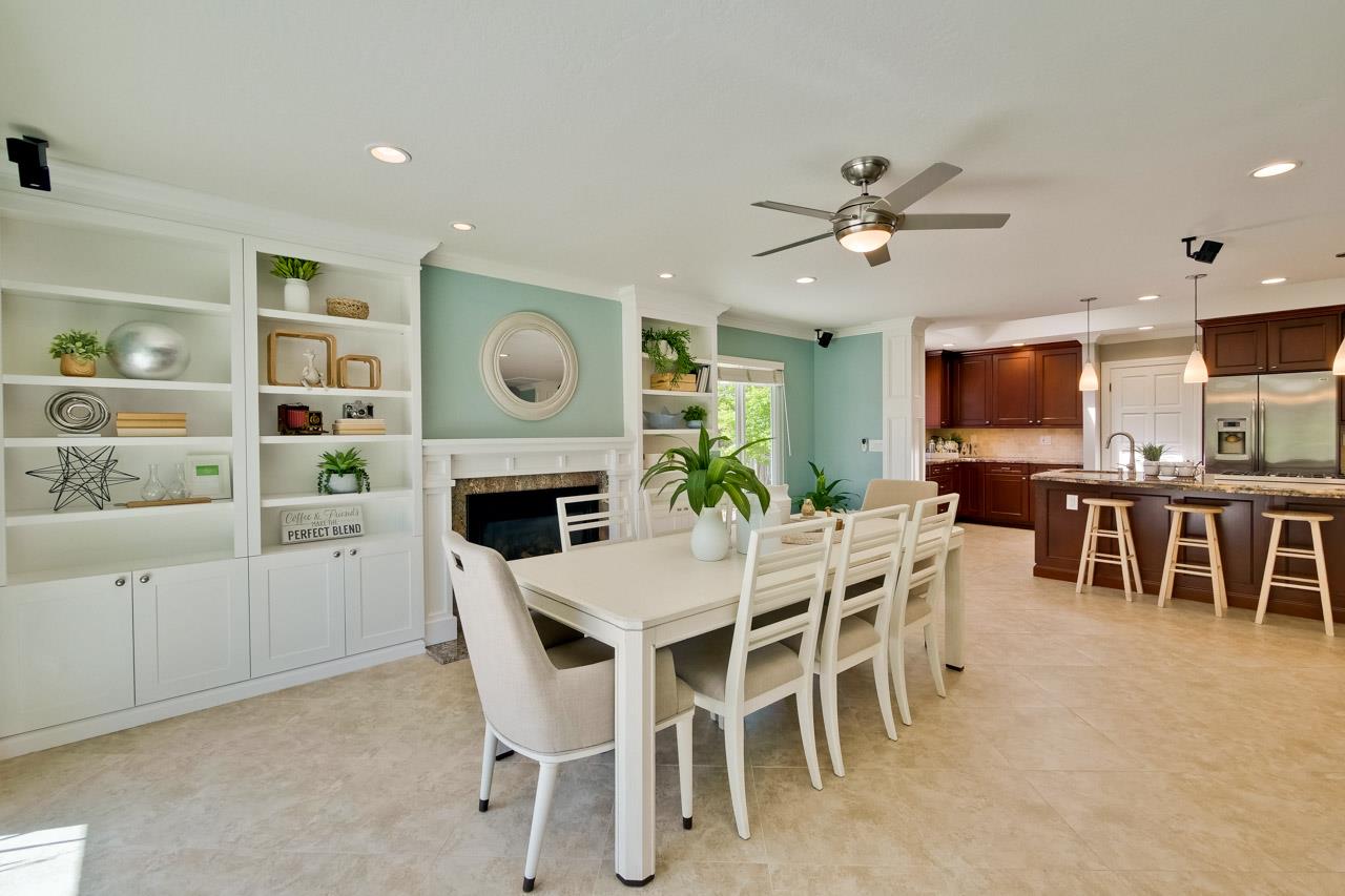 22266 Hartman Drive Cupertino, CA 95014 - Photo 28 of 73 a dining room with furniture a window and a fireplace
