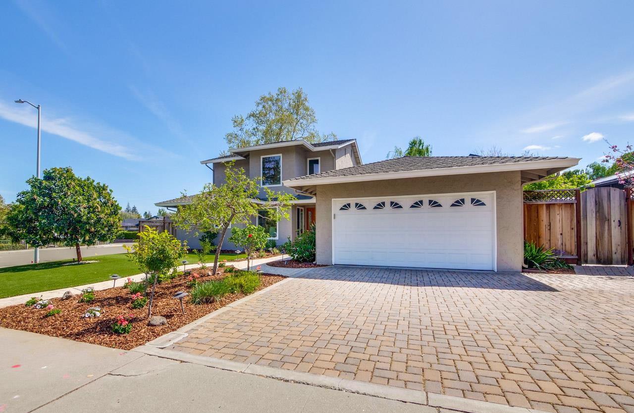 22266 Hartman Drive Cupertino, CA 95014 - Photo 3 of 73 a front view of a house with a yard and garage
