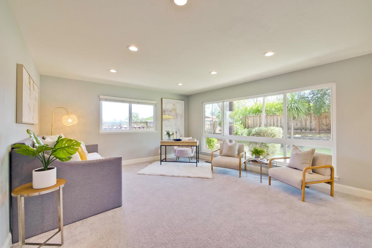 22266 Hartman Drive Cupertino, CA 95014 - Photo 32 of 73 a living room with furniture and a floor to ceiling window
