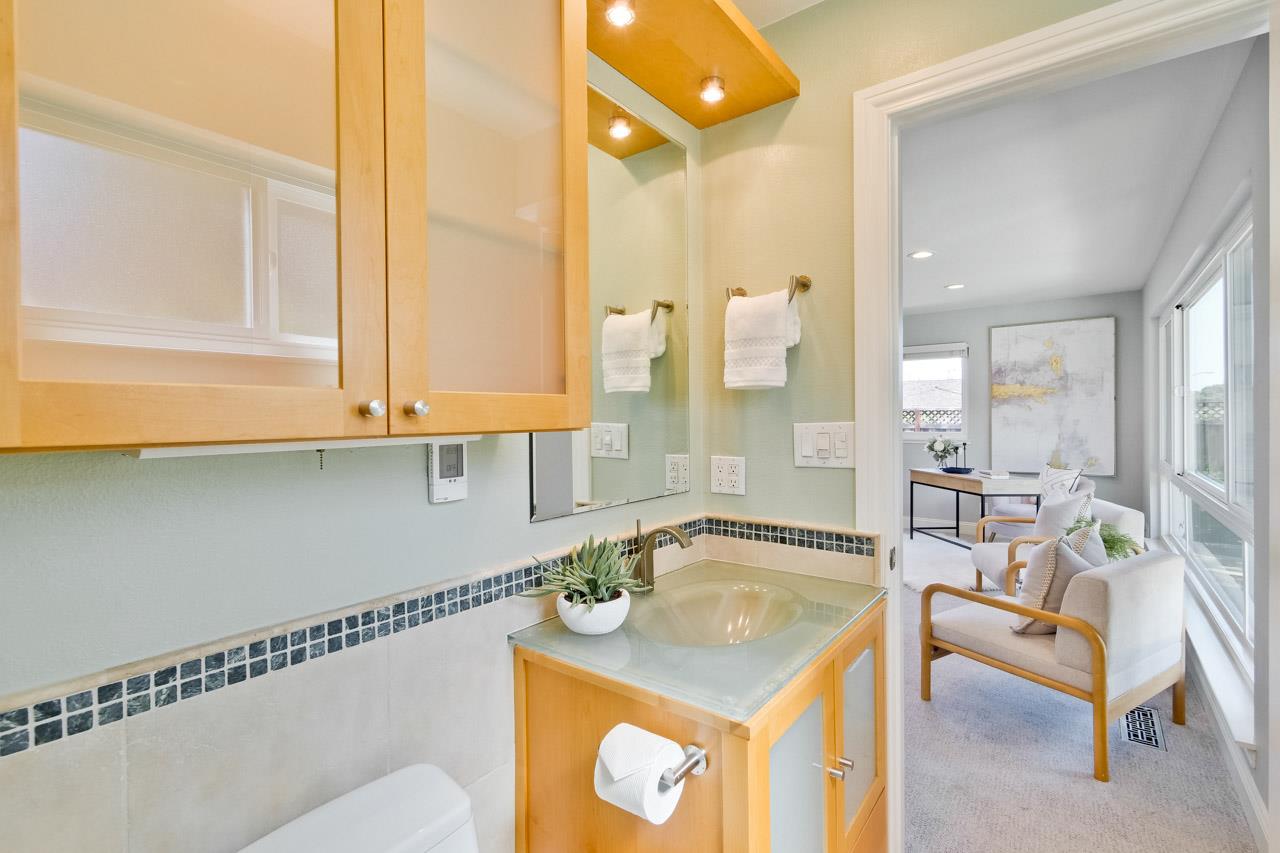 22266 Hartman Drive Cupertino, CA 95014 - Photo 42 of 73 a bathroom with a sink a mirror and a bathtub