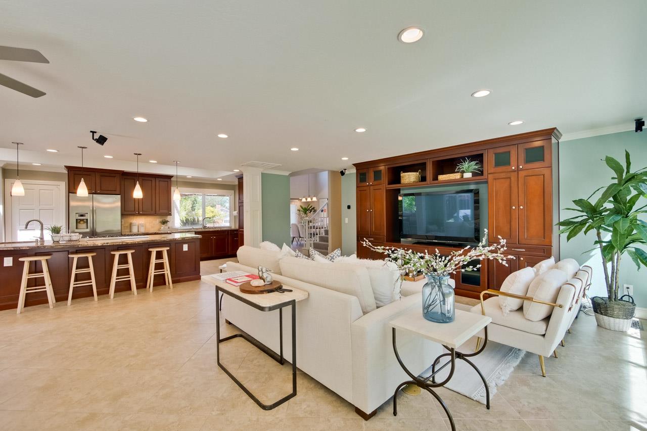 22266 Hartman Drive Cupertino, CA 95014 - Photo 7 of 73 a living room with furniture a flat screen tv and a refrigerator