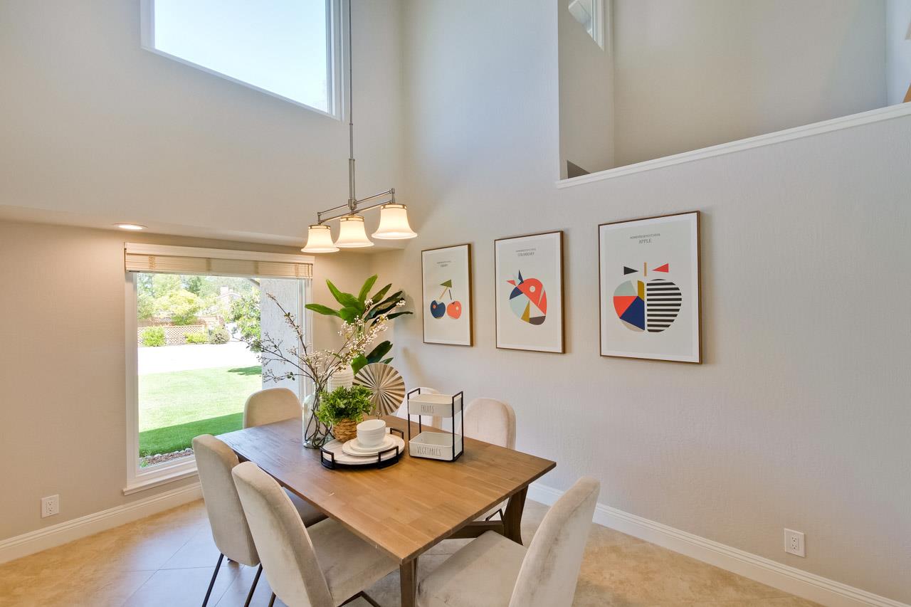 22266 Hartman Drive Cupertino, CA 95014 - Photo 10 of 73 a view of a dining room with furniture a potted plant and wooden floor