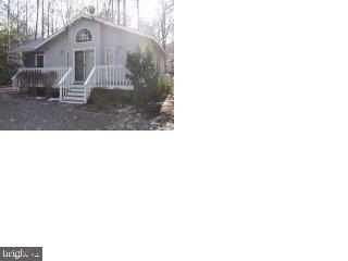 58 Capetown Road Ocean Pines, MD 21811 - Photo 1 of 2 a front view of a house with garden