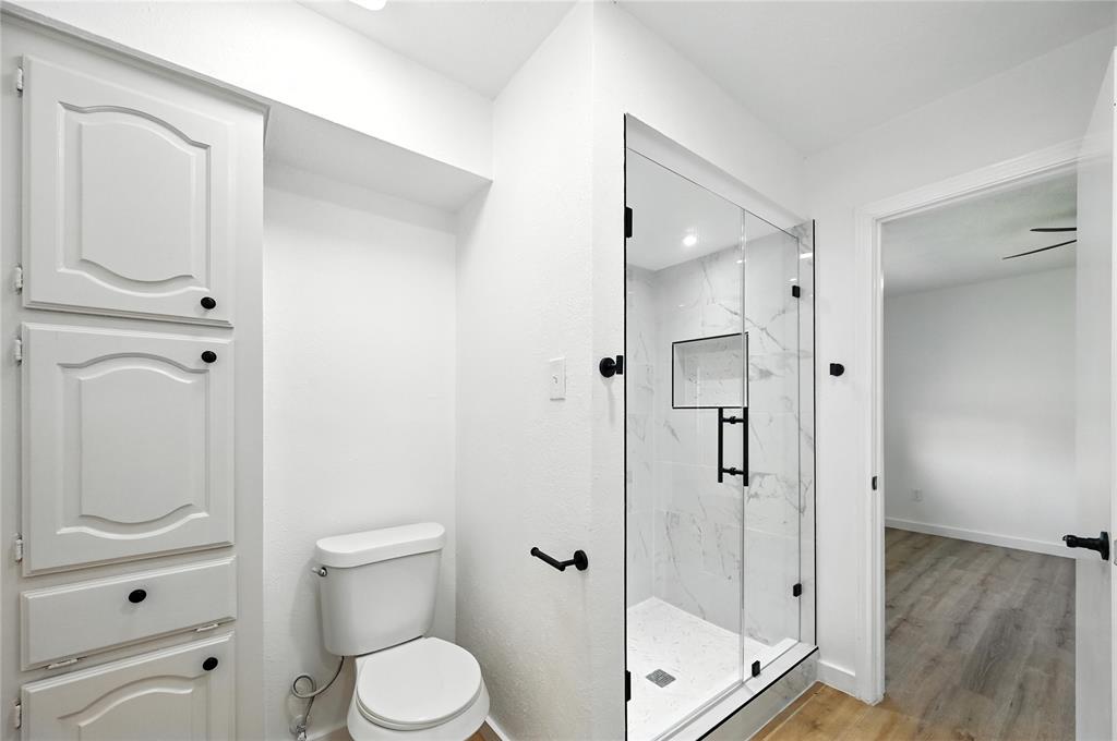3309 Larkin Lane Rowlett, TX 75089 - Photo 11 of 18 a bathroom with a shower a toilet and a sink