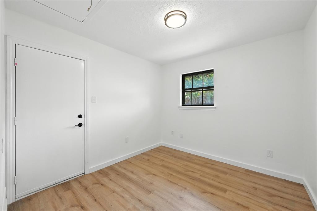 3309 Larkin Lane Rowlett, TX 75089 - Photo 3 of 18 an empty room with wooden floor and window