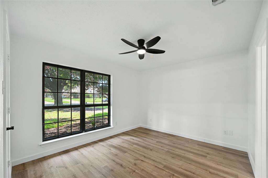 3309 Larkin Lane Rowlett, TX 75089 - Photo 9 of 18 an empty room with wooden floor and windows