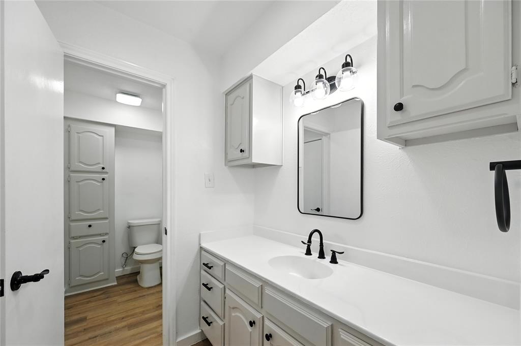 3309 Larkin Lane Rowlett, TX 75089 - Photo 10 of 18 a bathroom with a sink toilet and mirror