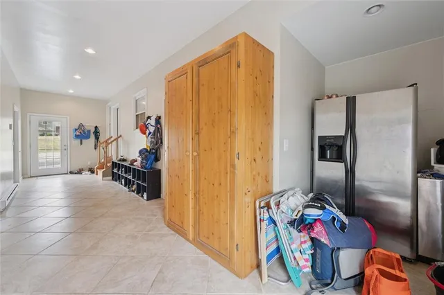 a view of a house with wooden deck and furniture