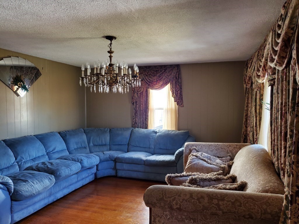 48 Merrill Road Springfield, MA 01119 - Photo 13 of 38 a living room with furniture and a chandelier