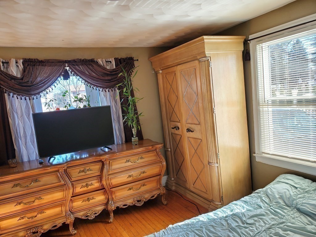 48 Merrill Road Springfield, MA 01119 - Photo 17 of 38 a bedroom with bed and flat screen tv