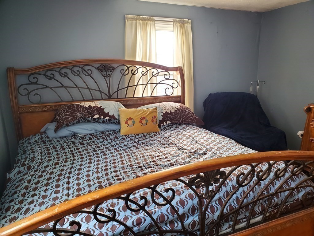 48 Merrill Road Springfield, MA 01119 - Photo 19 of 38 a bedroom with a bed and window