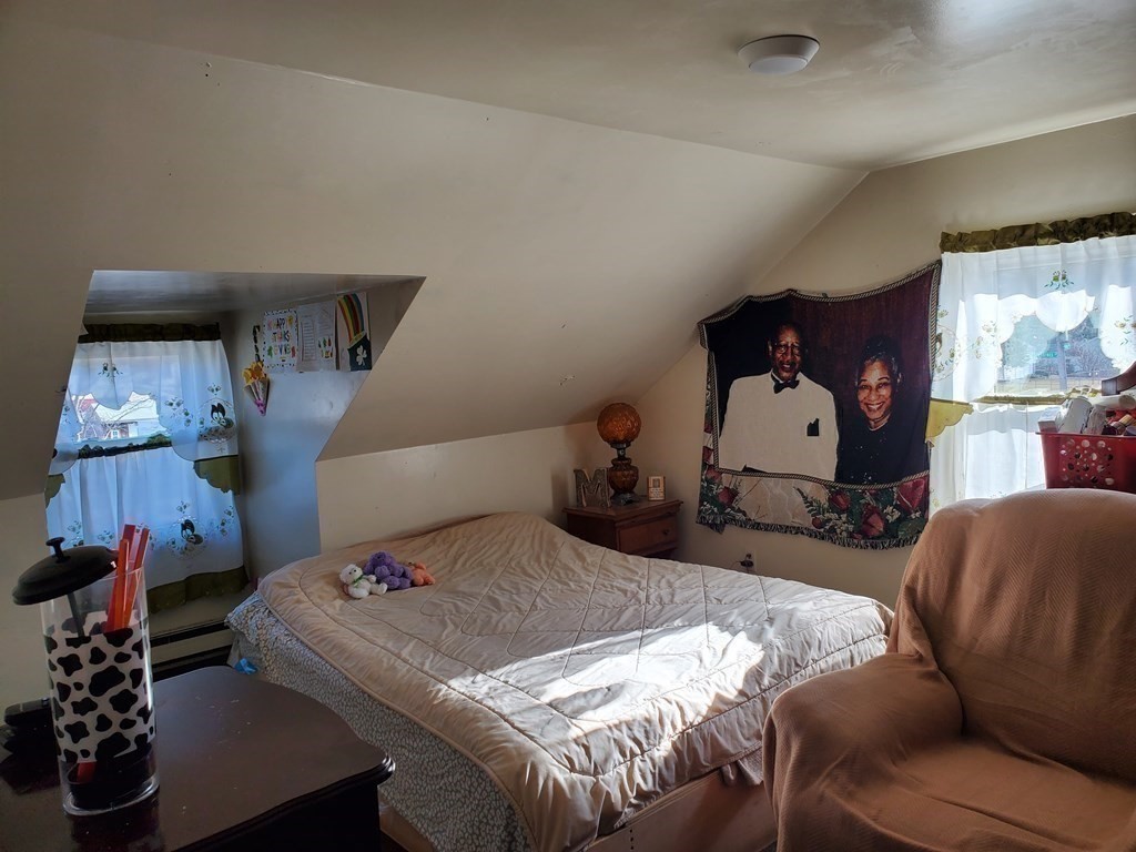 48 Merrill Road Springfield, MA 01119 - Photo 21 of 38 a bedroom with furniture and a wooden floor
