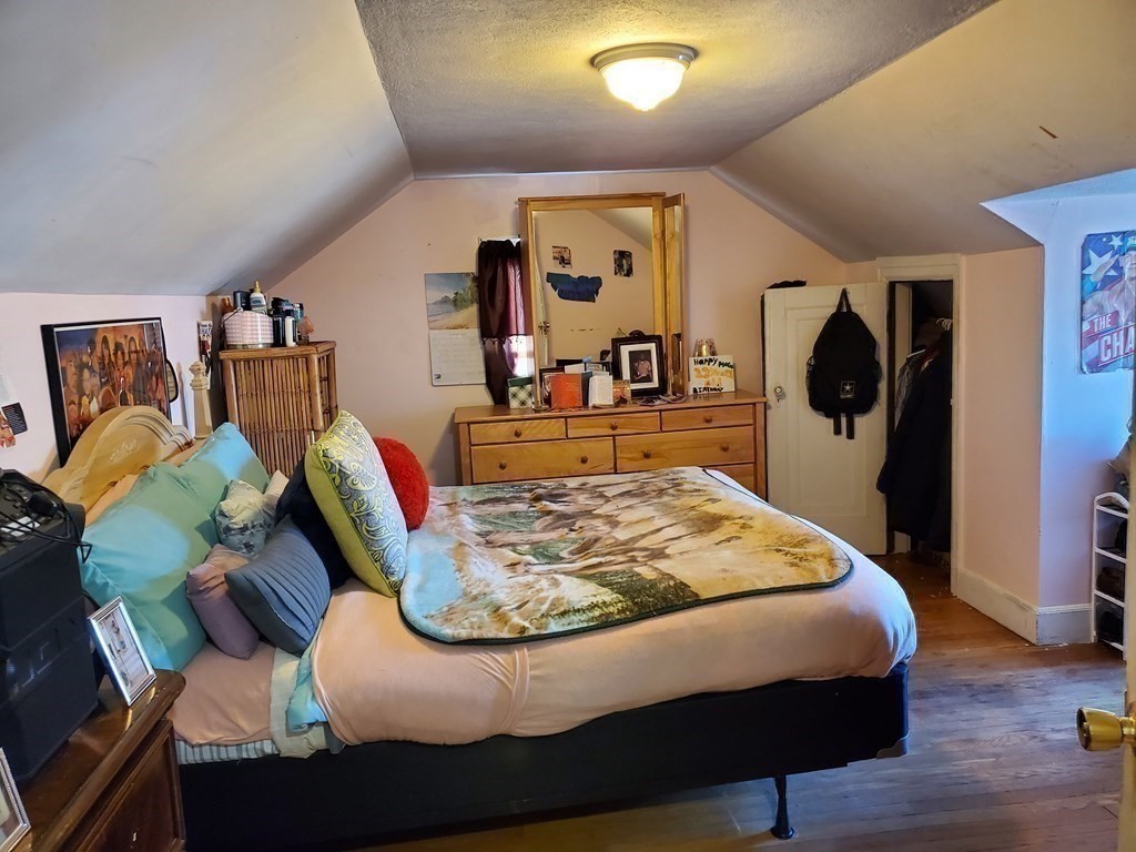 48 Merrill Road Springfield, MA 01119 - Photo 23 of 38 a bed sitting in a bedroom next to a tv