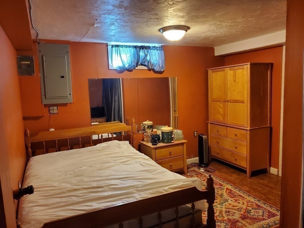 48 Merrill Road Springfield, MA 01119 - Photo 24 of 38 a bedroom with a bed and wooden floor