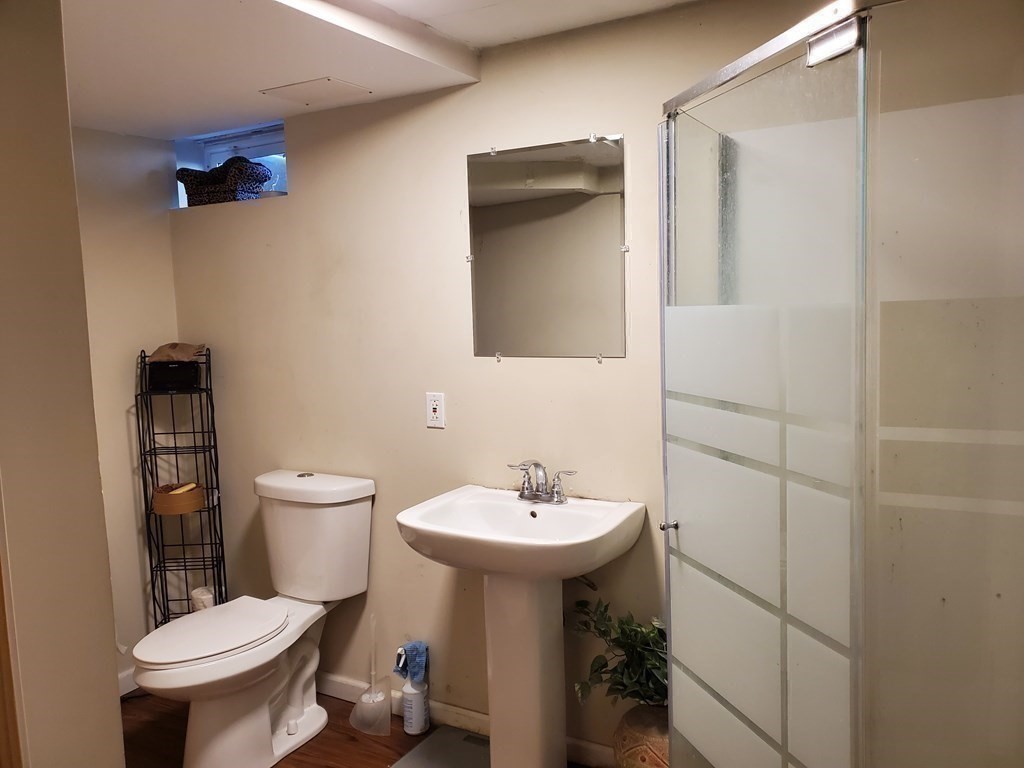 48 Merrill Road Springfield, MA 01119 - Photo 25 of 38 a bathroom with a sink toilet and a mirror