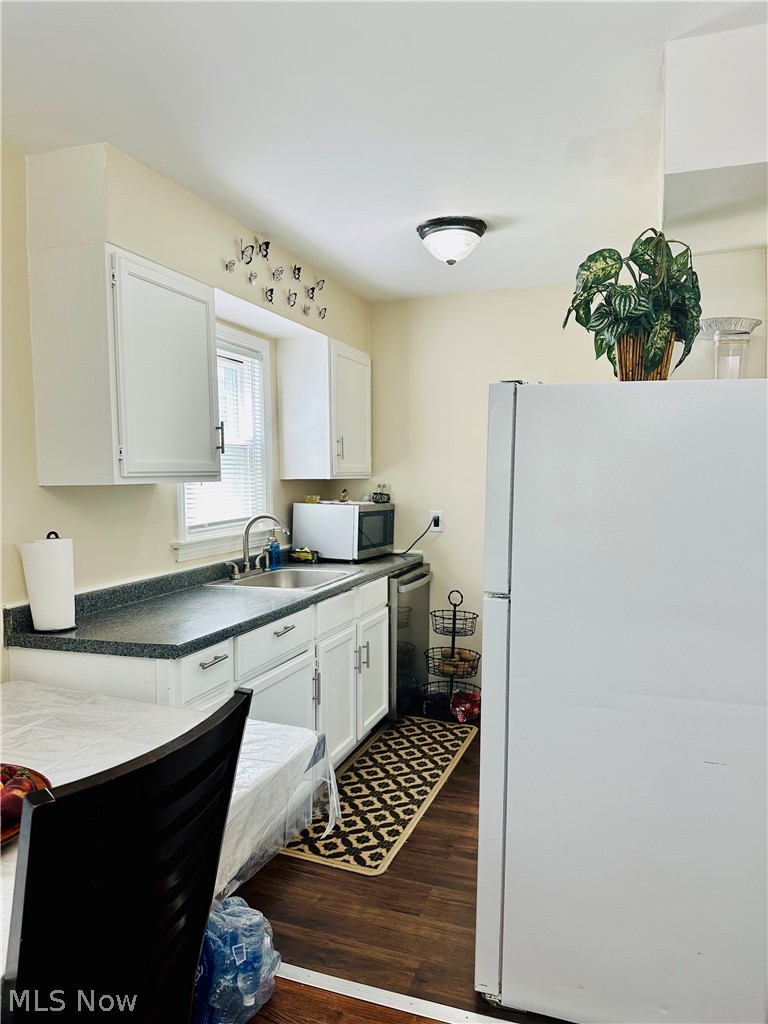 18613 Homeway Road Cleveland, OH 44135 - Photo 11 of 19 Kitchen with white refrigerator, dark wood-type flooring, sink, and white cabinetry