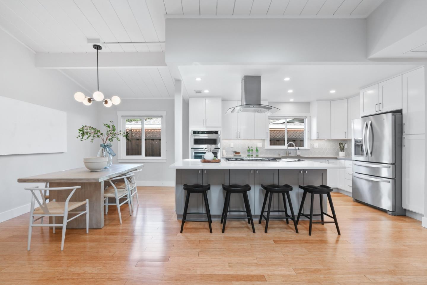 643 Crestview Drive San Jose, CA 95050 - Photo 7 of 76 a kitchen with stainless steel appliances kitchen island granite countertop a dining table chairs and white cabinets