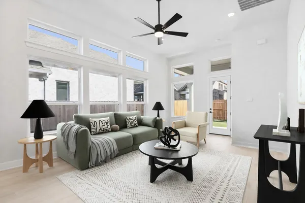 a living room with furniture a rug and a chandelier