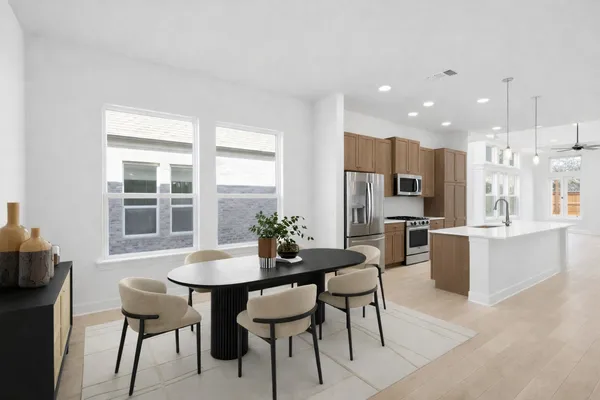 a view of a dining room with furniture and window