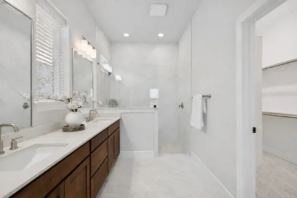 a bathroom with a double vanity sink mirror and double