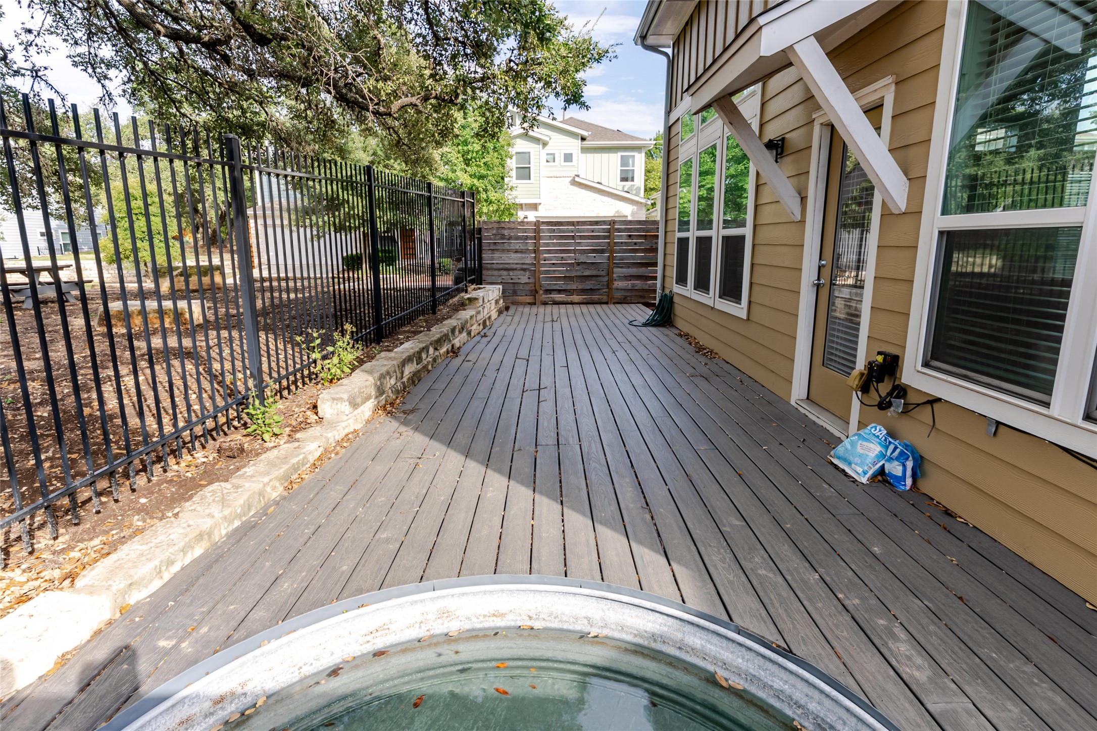 1400 Homespun Road Austin, TX 78745 - Photo 28 of 30 A long wooden deck provides an inviting outdoor space alongside the home.