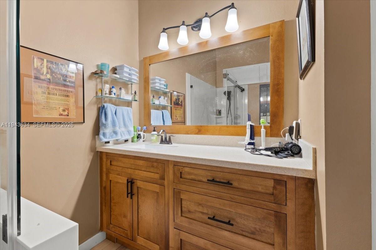 7120 Southwest 112th Avenue Miami, FL 33173 - Photo 13 of 27 a bathroom with a sink and a mirror