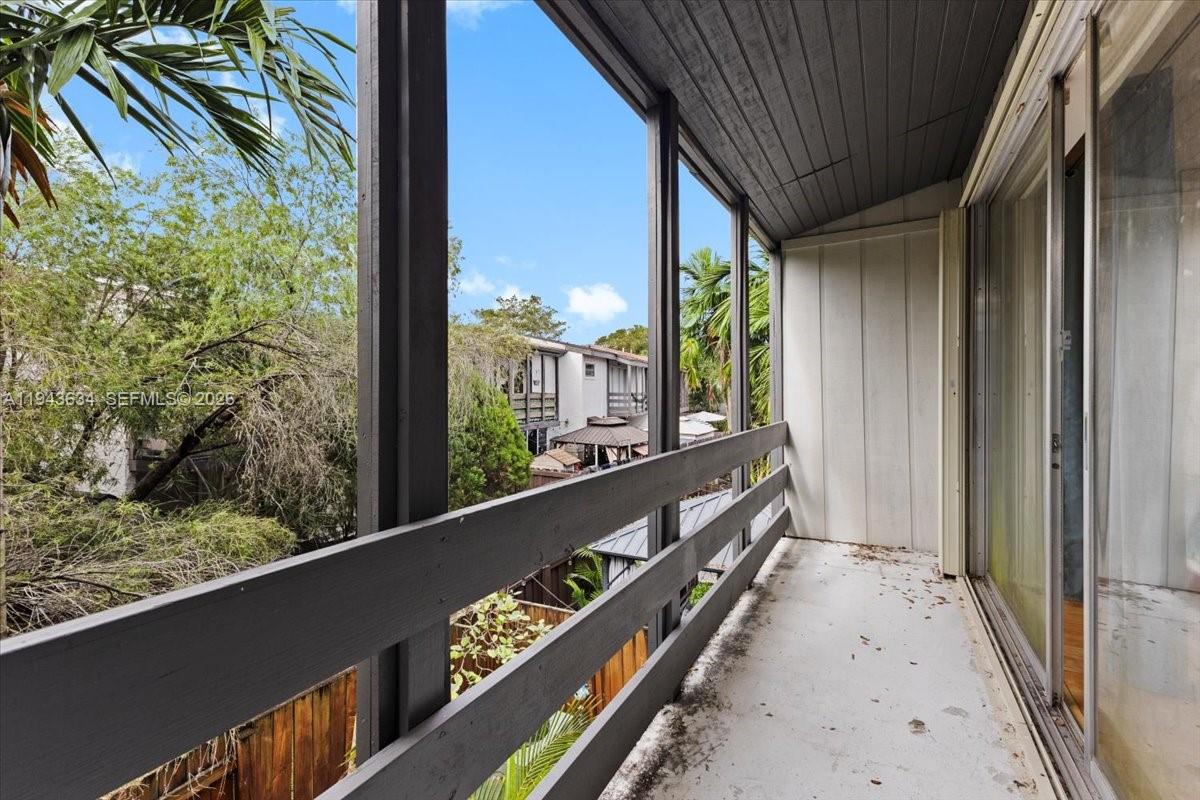 7120 Southwest 112th Avenue Miami, FL 33173 - Photo 16 of 27 a view of a balcony with floor to ceiling window and wooden floor