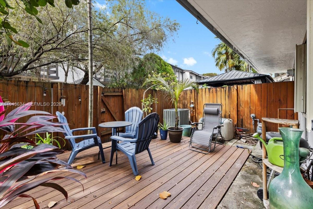 7120 Southwest 112th Avenue Miami, FL 33173 - Photo 17 of 27 a view of deck with table and chairs and potted plants