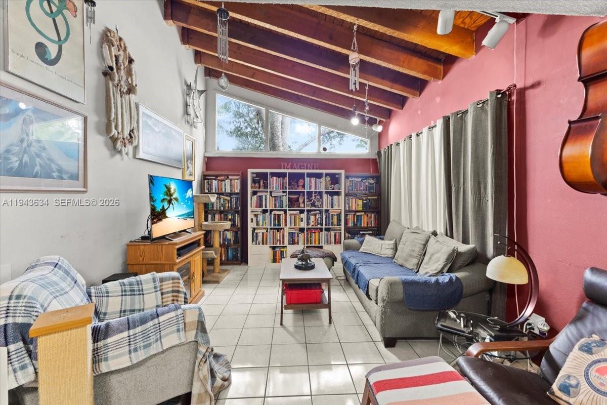 7120 Southwest 112th Avenue Miami, FL 33173 - Photo 5 of 27 a living room with patio furniture and a fireplace